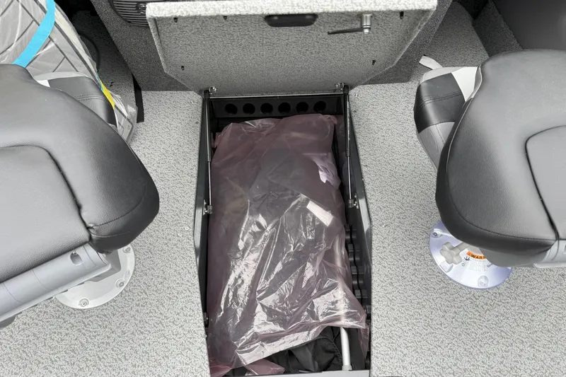 Slide: The Image of 2026 Crestliner 1950 Sportfish interior storage compartment between two seats. - 14