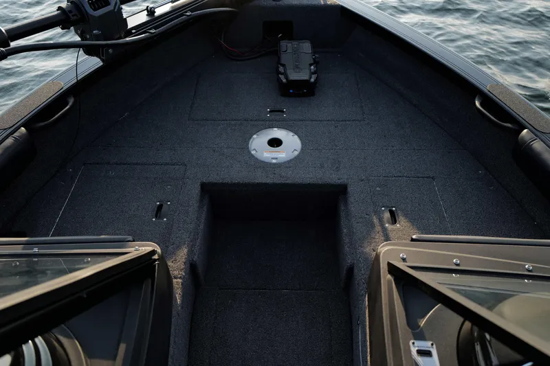 Slide: The Image of 2026 Crestliner 1950 Sportfish boat interior with carpeted deck and storage compartments. - 19