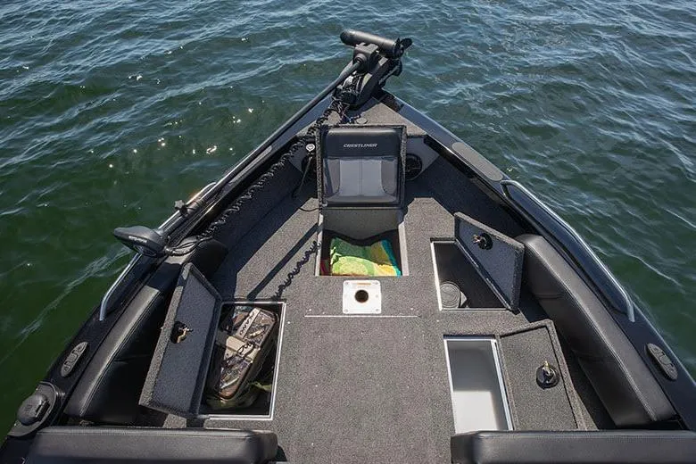 Slide: The Image of 2026 Crestliner 1950 Sportfish boat interior with storage compartments on a lake. - 20