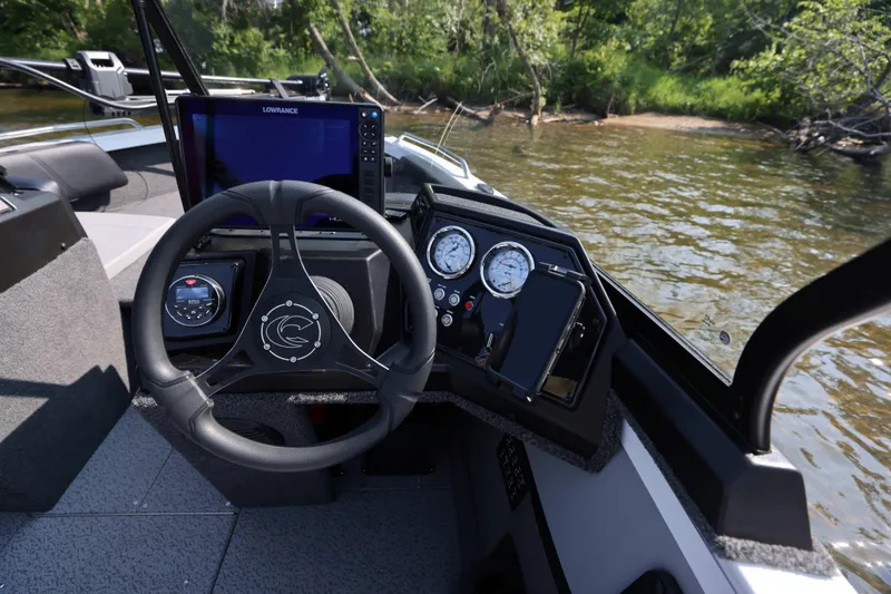 Slide: The Image of 2026 Crestliner 1950 Sportfish dashboard with steering wheel and navigation system. - 21
