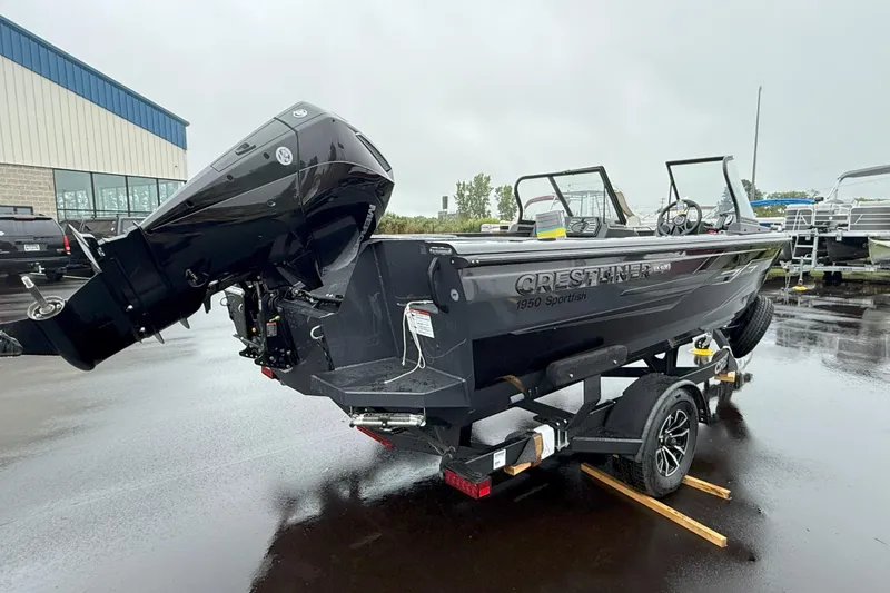 Slide: The Image of 2026 Crestliner 1950 Sportfish boat on trailer, parked outdoors on wet pavement. - 3