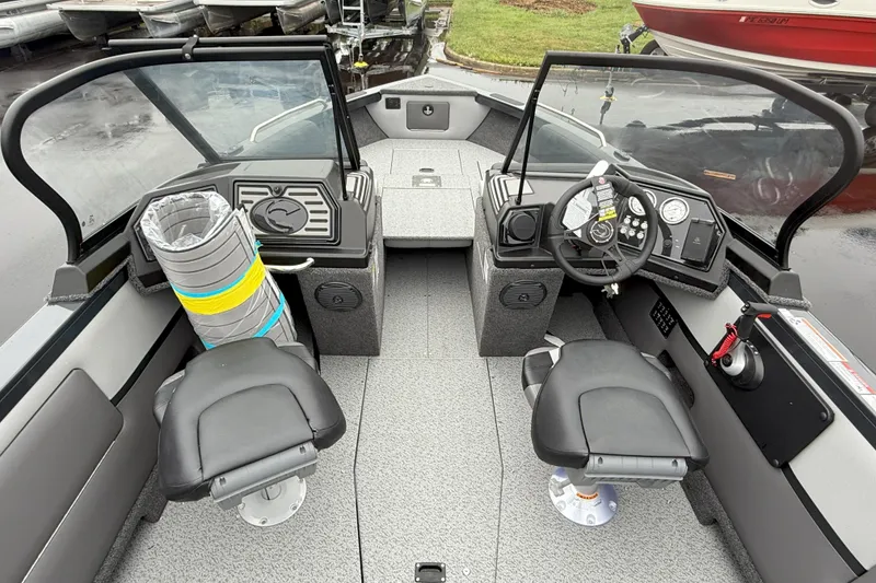 Slide: The Image of 2026 Crestliner 1950 Sportfish boat interior with dual seats and modern dashboard controls. - 6