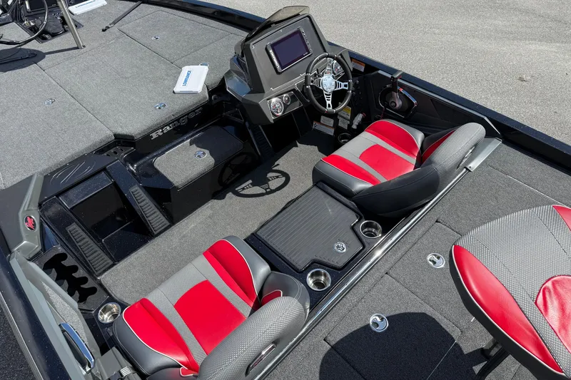 Slide: The Image of 2021 Ranger Z518 boat interior with red and gray seats, steering console, and carpeted deck. - 11