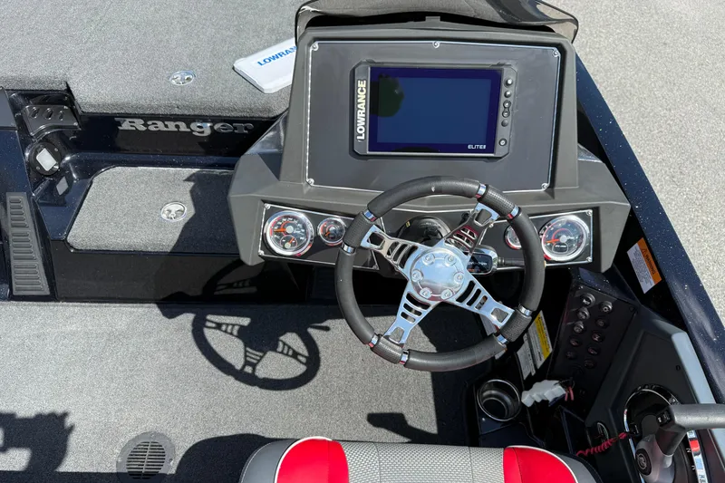 Slide: The Image of 2021 Ranger Z518 boat dashboard with steering wheel and Lowrance Elite display. - 13