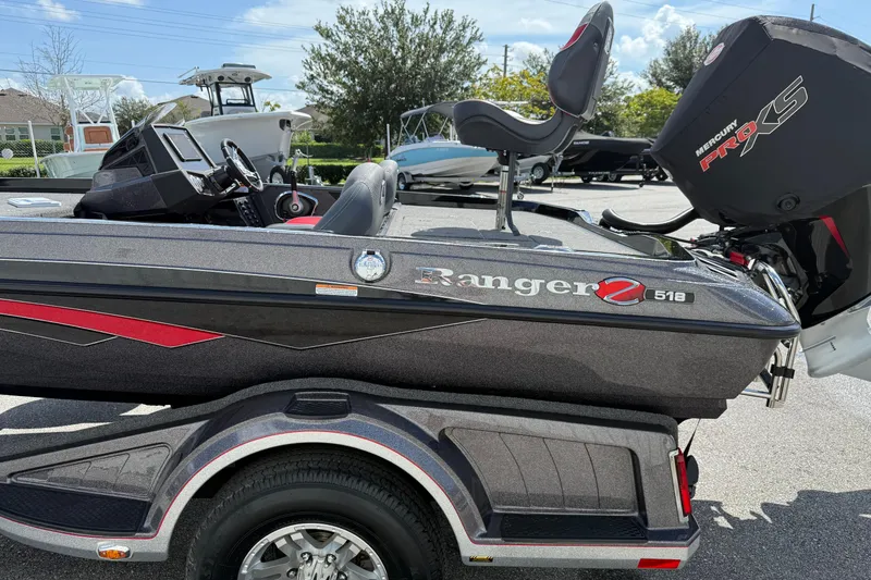 Slide: The Image of 2021 Ranger Z518 boat with Mercury Pro XS engine, parked outdoors. - 6