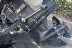 Slide: The Image of 1998 Sea Ray 190 Bow Rider outboard motor with visible propeller and trim mechanism. - 7