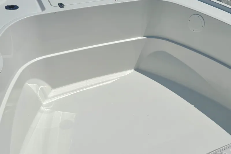Slide: The Image of 2026 Parker 18SE Center Console boat interior, showcasing sleek white design and spacious layout. - 9