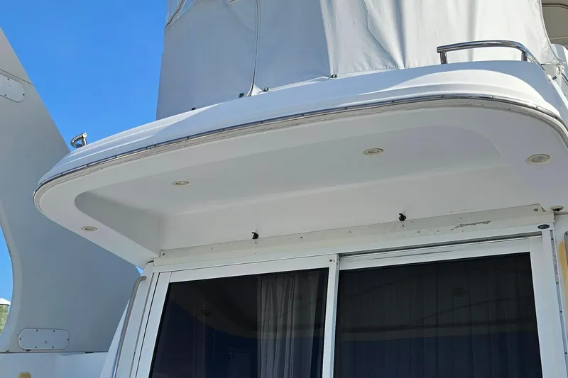 Slide: The Image of 2002 Carver 410 Sport Sedan yacht, featuring a sleek white exterior and modern design elements. - 1