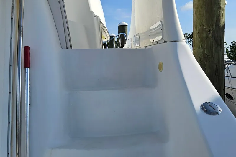 Slide: The Image of Staircase on 2002 Carver 410 Sport Sedan yacht, docked with clear sky background. - 10