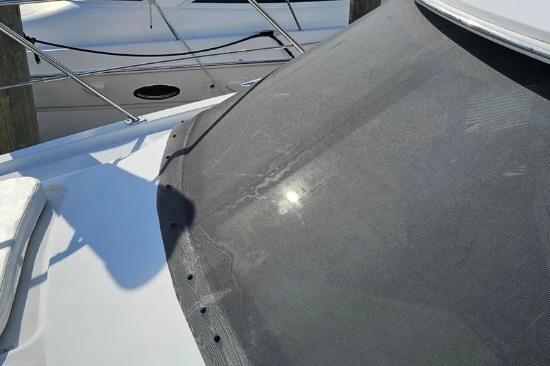 Slide: The Image of 2002 Carver 410 Sport Sedan boat with sunlit windshield cover at dock. - 13
