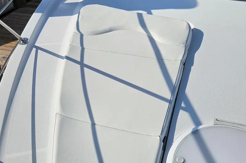 Slide: The Image of Sunpad on 2002 Carver 410 Sport Sedan yacht, featuring sleek white upholstery. - 14