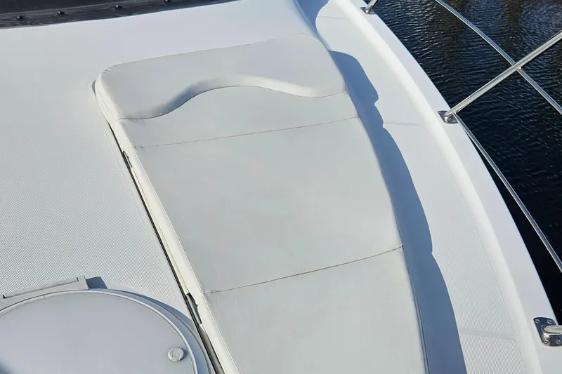 Slide: The Image of Sunpad on 2002 Carver 410 Sport Sedan yacht, overlooking water. - 15