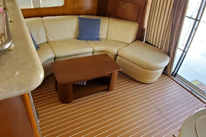 Slide: The Image of Luxurious interior of 2002 Carver 410 Sport Sedan with cream sofa and wooden table. - 19