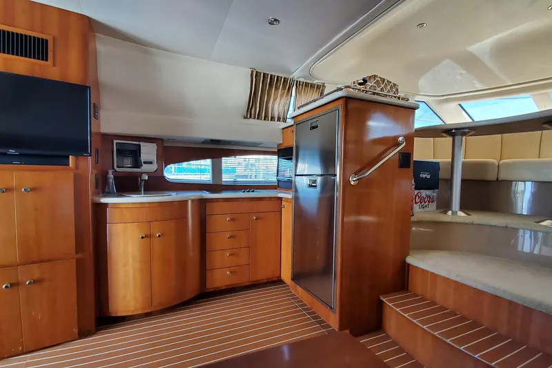 Slide: The Image of Interior of 2002 Carver 410 Sport Sedan yacht with wood cabinetry and modern amenities. - 20