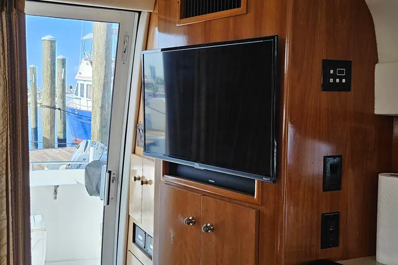 Slide: The Image of Interior of 2002 Carver 410 Sport Sedan with TV and wooden cabinetry. - 23