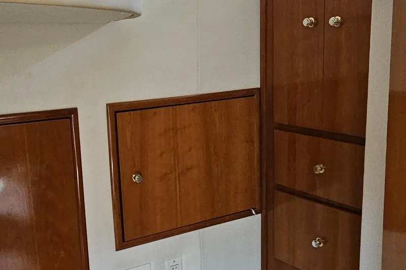 Slide: The Image of Wooden cabinetry inside a 2002 Carver 410 Sport Sedan yacht interior. - 25
