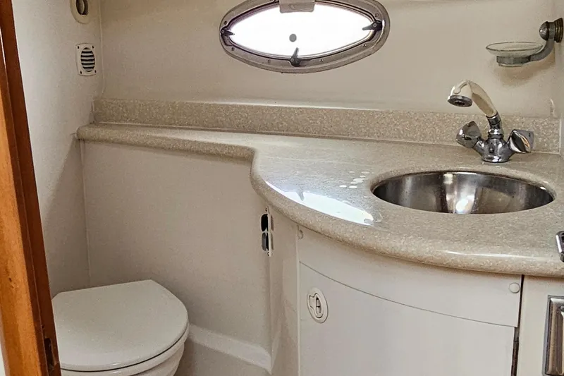 Slide: The Image of 2002 Carver 410 Sport Sedan bathroom with sink, faucet, and oval window. - 27