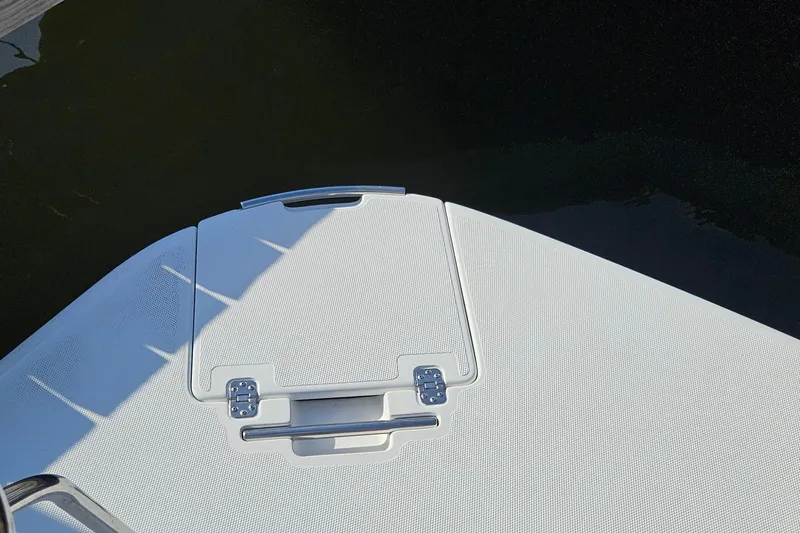 Slide: The Image of 2002 Carver 410 Sport Sedan boat deck with hatch, near water. - 30