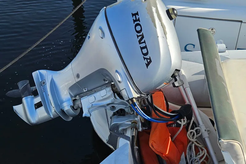 Slide: The Image of Outboard motor on a Carver 410 Sport Sedan, 2002 model, docked by water. - 34