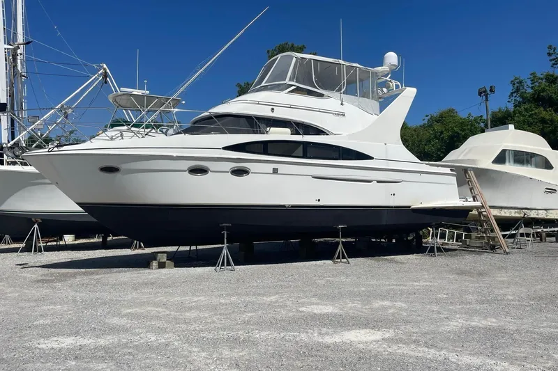 Slide: The Image of 2002 Carver 410 Sport Sedan yacht on dry dock under clear blue sky. - 35