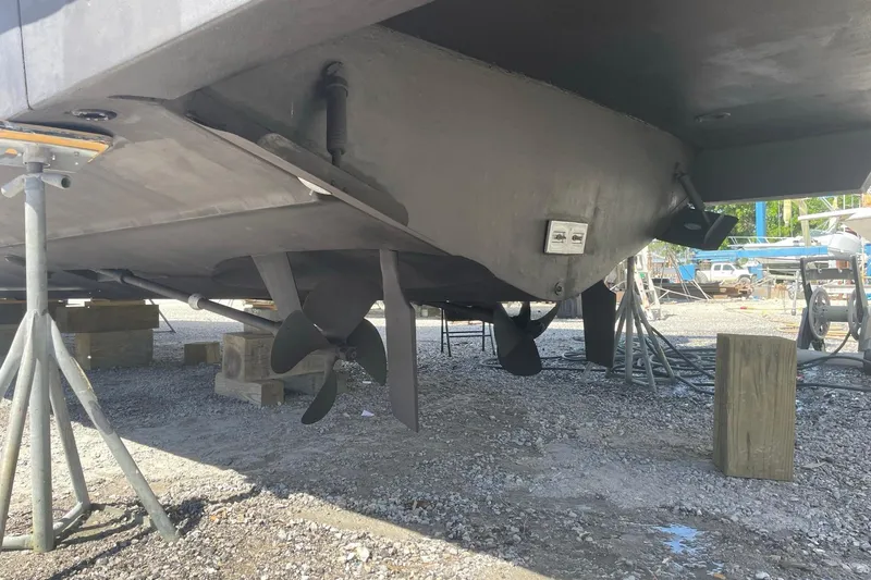 Slide: The Image of Underside view of a 2002 Carver 410 Sport Sedan boat on stands. - 36