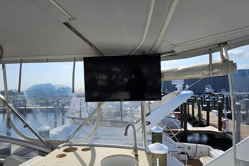 Slide: The Image of Interior view of a 2002 Carver 410 Sport Sedan yacht with a mounted TV. - 8