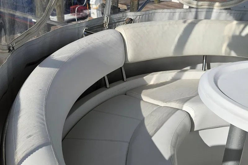 Slide: The Image of 2002 Carver 410 Sport Sedan interior with curved white seating and table. - 9