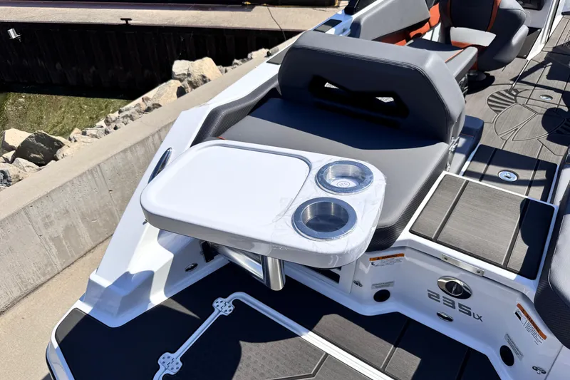 Slide: The Image of 2026 Scarab 235 LX Wake boat interior with seating and cup holders. - 13