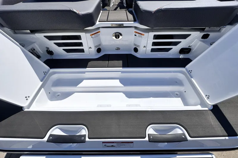 Slide: The Image of 2026 Scarab 235 LX Wake boat storage compartment with open hatches and seating. - 15