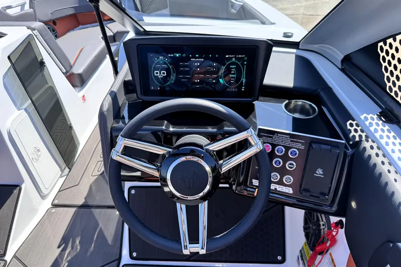 Slide: The Image of 2026 Scarab 235 LX Wake boat dashboard with modern steering wheel and digital display. - 19