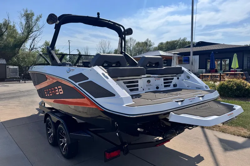 Slide: The Image of 2026 Scarab 235 LX Wake boat on trailer, featuring sleek design and modern amenities. - 4