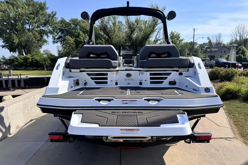Slide: The Image of 2026 Scarab 235 LX Wake boat, rear view, docked on a sunny day. - 6