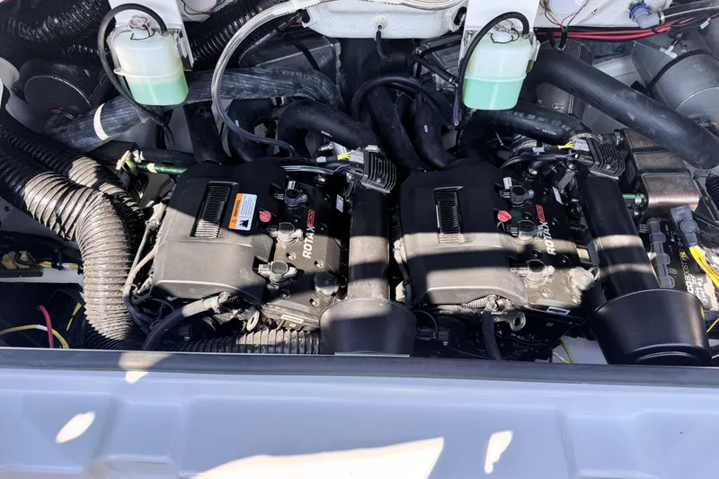 Slide: The Image of Engine compartment of 2026 Scarab 235 LX Wake boat, featuring dual Rotax engines. - 8