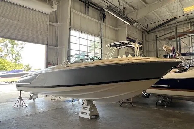 The Image of 2021 Chris-Craft Launch 27 boat in a spacious indoor storage facility. - 0