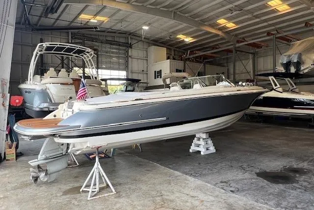 Slide: The Image of 2021 Chris-Craft Launch 27 boat in a storage facility, showcasing sleek design and craftsmanship. - 1