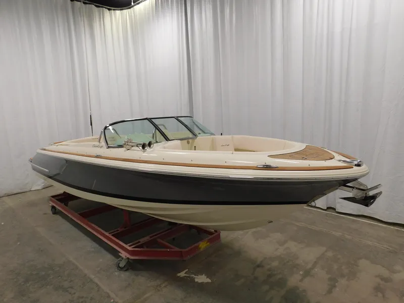 Slide: The Image of 2021 Chris-Craft Launch 27 boat in showroom, side view, on display stand. - 13
