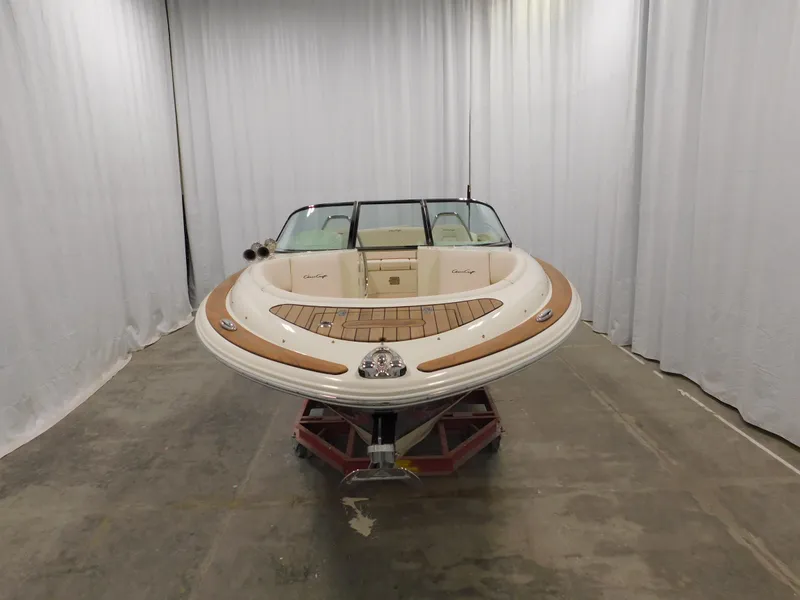 Slide: The Image of 2021 Chris-Craft Launch 27 boat in showroom, featuring elegant design and wood accents. - 14