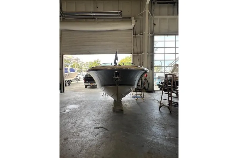 Slide: The Image of 2021 Chris-Craft Launch 27 boat in a garage, front view. - 4
