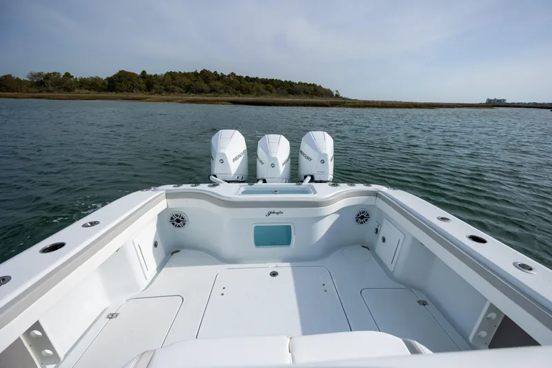 Slide: The Image of 2025 Yellowfin 34 Offshore boat with triple Mercury engines on calm water. - 10