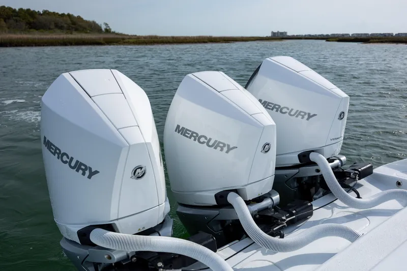 Slide: The Image of Triple Mercury outboard engines on a 2025 Yellowfin 34 Offshore boat in open water. - 11