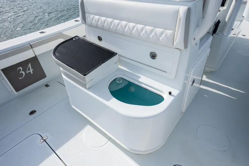 Slide: The Image of 2025 Yellowfin 34 Offshore boat interior with seating and storage compartment. - 14