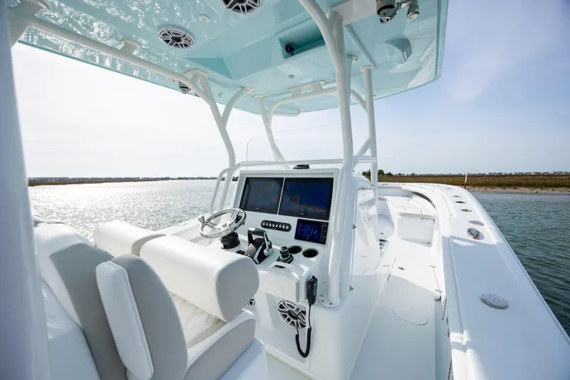 Slide: The Image of 2025 Yellowfin 34 Offshore boat interior with modern controls and ocean view. - 16