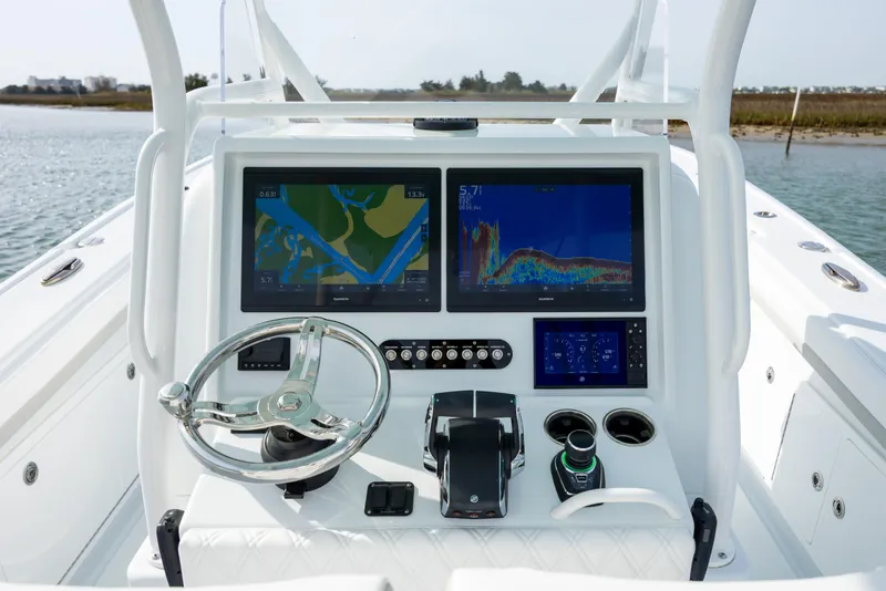 Slide: The Image of 2025 Yellowfin 34 Offshore boat dashboard with advanced navigation and control systems. - 18