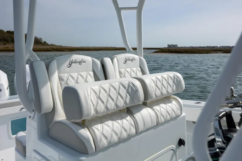 Slide: The Image of 2025 Yellowfin 34 Offshore boat with luxurious white seating on open water. - 20