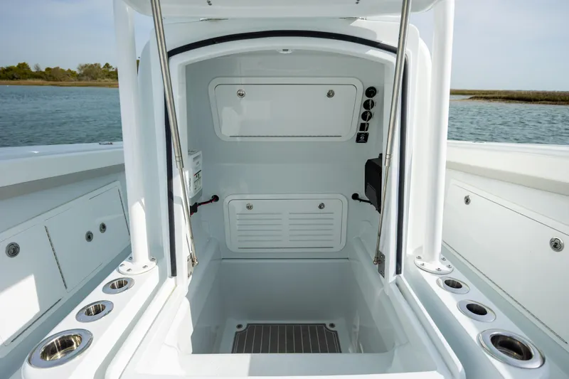 Slide: The Image of 2025 Yellowfin 34 Offshore boat interior with storage compartments and rod holders. - 26