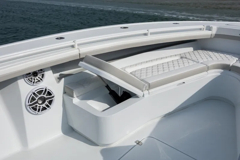 Slide: The Image of 2025 Yellowfin 34 Offshore boat interior with cushioned seating and built-in speakers. - 27