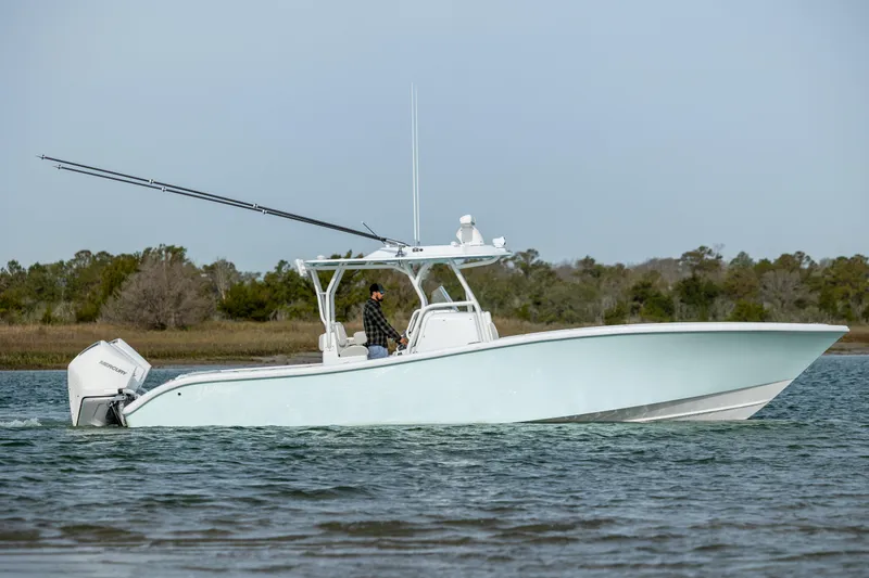 Slide: The Image of 2025 Yellowfin 34 Offshore boat on water, front view, with natural background. - 4