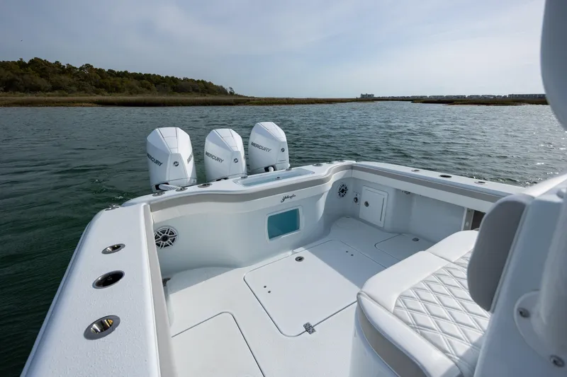 Slide: The Image of 2025 Yellowfin 34 Offshore boat with triple Mercury engines on calm water. - 9