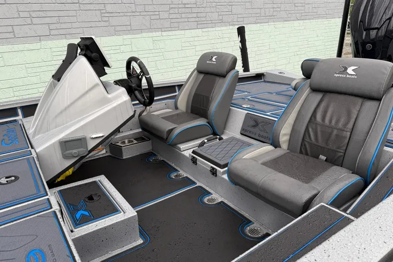Slide: The Image of Interior of 2026 Xpress X19 Pro boat with modern seating and steering console. - 6