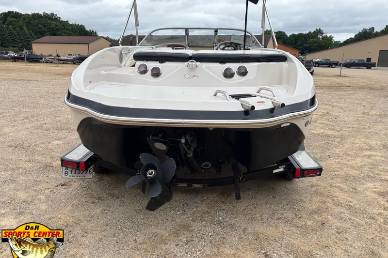 Slide: The Image of 2011 Tahoe Q7i boat on trailer, rear view, parked outdoors. - 24